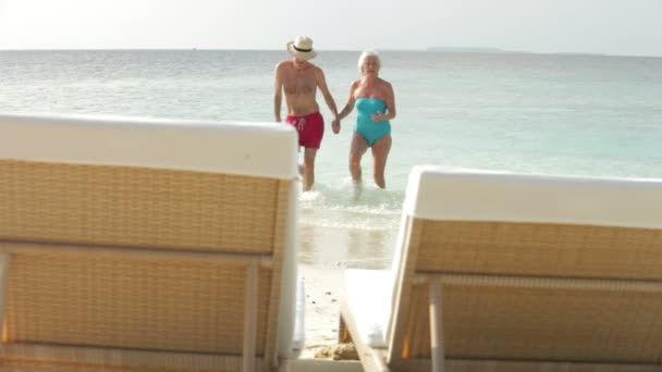 Seniorenpaar geht aus dem Meer — Stockvideo