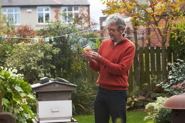 Mature Man Looking At Honey — Stock Photo, Image