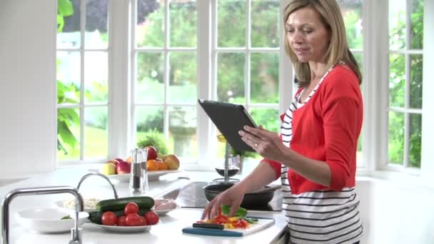 Woman checks Recipe On Digital Tablet — Stock Video