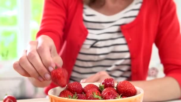 Woman picks a ripe strawberry — Stock Video