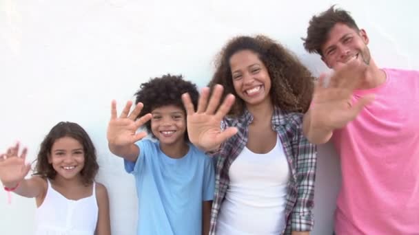 Family standing outdoors and waving — Stock Video