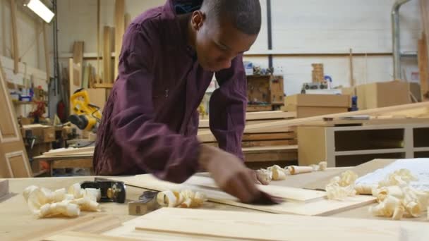 Male Apprentice Sanding Wood — Stock Video