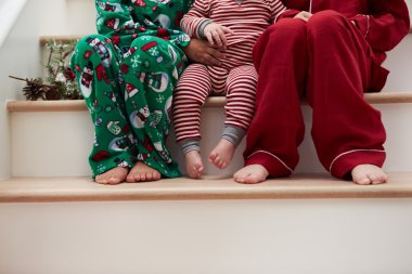 Three Children In Pajamas At Christmas clipart