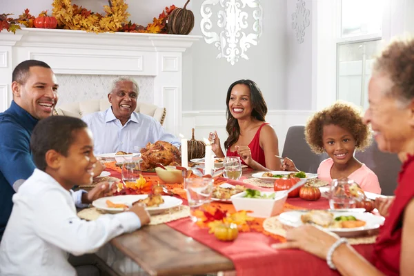 Family Enjoying Thanksgiving Meal At Table Royalty Free Stock Photos