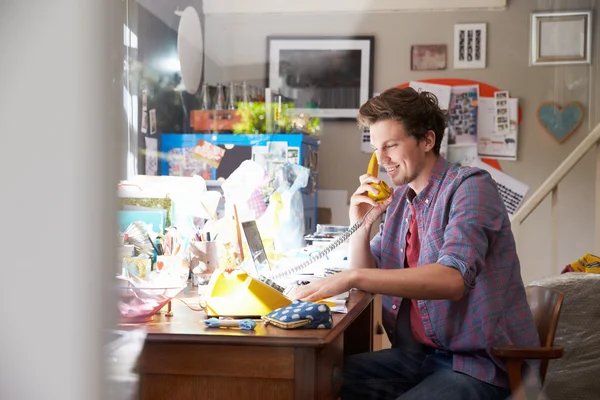 Man Using Laptop From Home Office