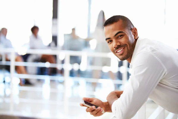 Man using mobile phone in office