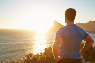 Young man contemplating after jogging clipart