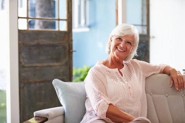 Smiling Senior Woman Sitting On Sofa — Stock Photo, Image