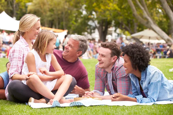 Family Relaxing At Summer Event