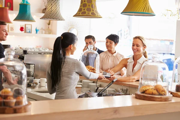 Mulher pagando seu pedido em um café — Fotografia de Stock