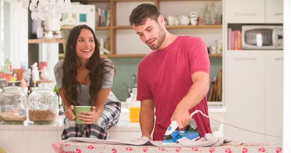 Woman Watching Man Ironing Shirt — Stock Photo, Image