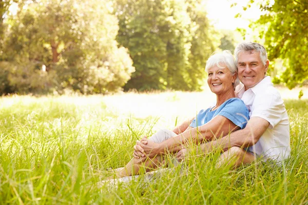 Senior paar zitten samen op gras — Stockfoto