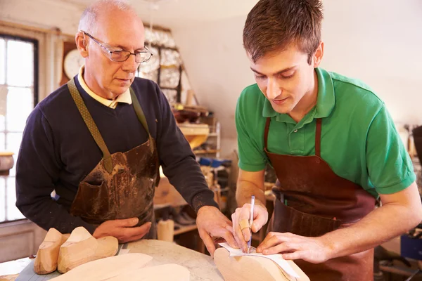 Shoemaker training apprentice to make shoe lasts — Stock Photo, Image