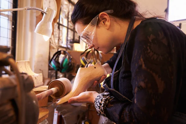 Shoemaker sanding shoe lasts in a workshop — Stock Photo, Image