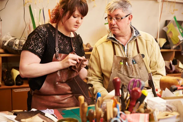 Shoemaker training apprentice to work with leather — Stock Photo, Image