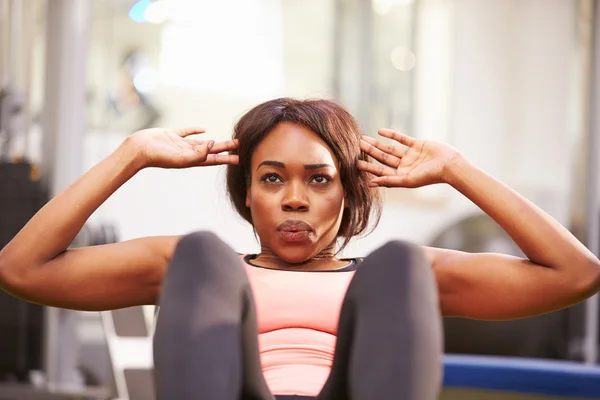 Woman doing crunches in a gym — Stock Photo, Image