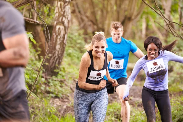 Competitors running in a forest — Stock Photo, Image