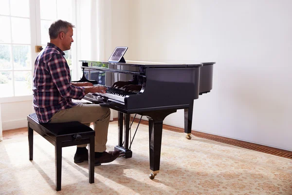 Hombre aprendiendo a tocar el piano —  Fotos de Stock