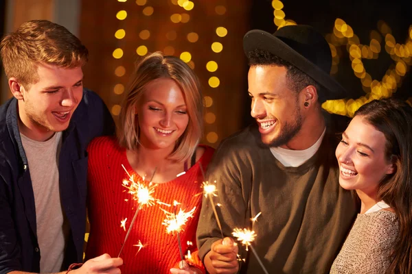 Friends Lighting Sparklers At Party — Stock Photo, Image