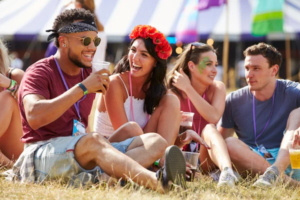 Venner som sitter på musikkfestival – stockfoto