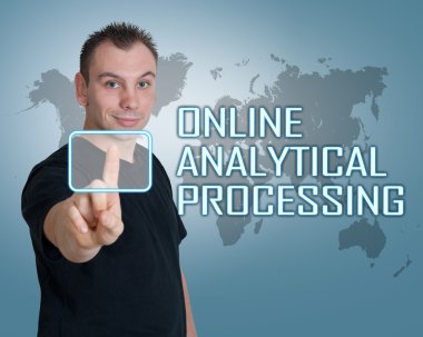 Young man press digital Online Analytical Processing button on interface in front of him