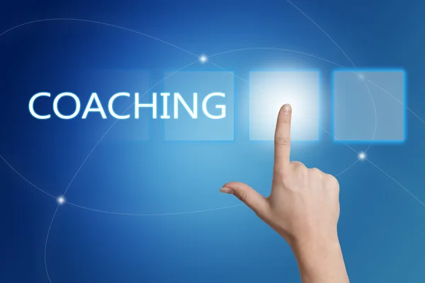 Coaching - hand pressing button on interface with blue background. — Stock fotografie