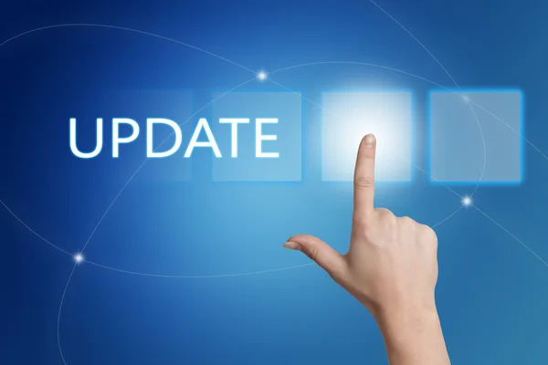 Update - hand pressing button on interface with blue background. — Stok fotoğraf
