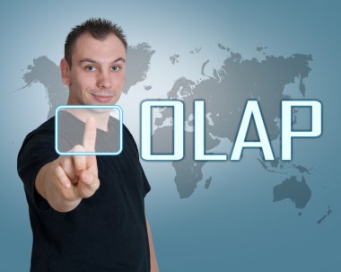 Young man press digital OLAP - Online Analytical Processing button on interface in front of him