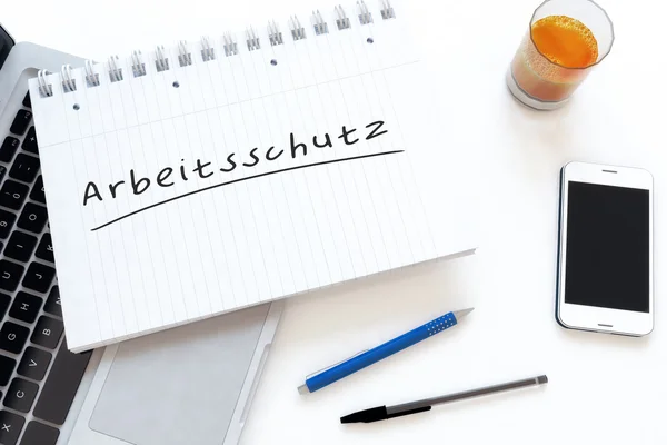 Arbeitsschutz - německé slovo pro bezpečnost práce - ručně text v poznámkovém bloku na stůl - 3d render obrázek. — Stock fotografie