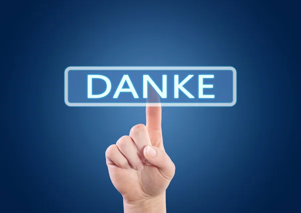 Danke - german word for thank you - hand pressing button on interface with blue background. — Stok fotoğraf