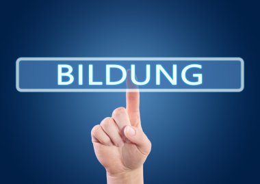 Bildung - german word for education - hand pressing button on interface with blue background.