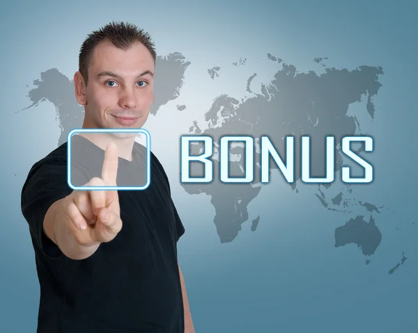 Young man press digital Bonus button on interface in front of him — Stock Photo, Image
