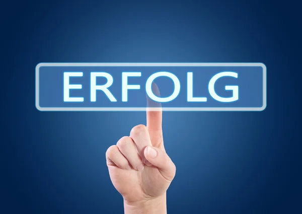 Erfolg - german word for success or achievement - hand pressing button on interface with blue background. — Stok fotoğraf