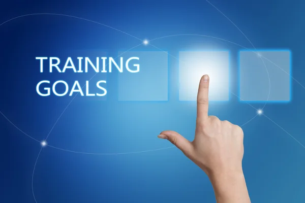 Training Goals - hand pressing button on interface with blue background. — Stock Photo, Image