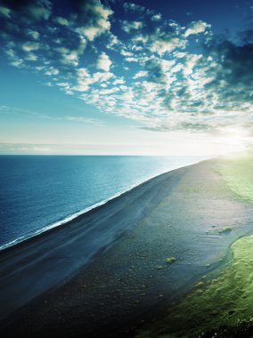 the black sand beach from the cliff of Dyrholaeyjarviti, Iceland clipart