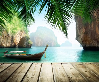 Adaman sea and wooden boat in Thailand clipart