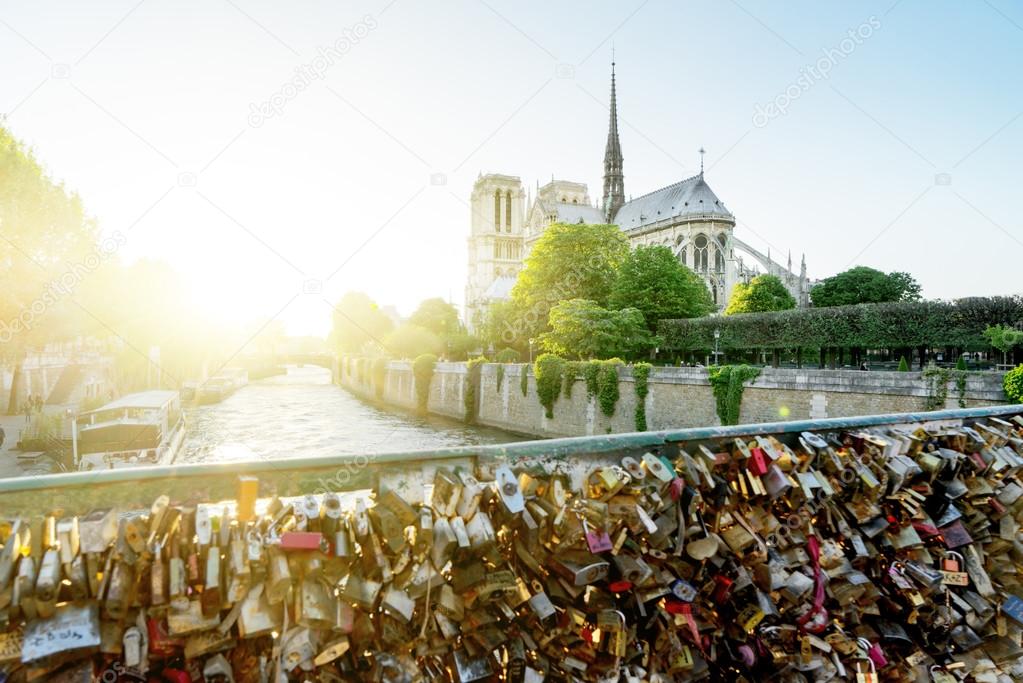 View of Notre Dame cathedral in Paris with famous locks of love