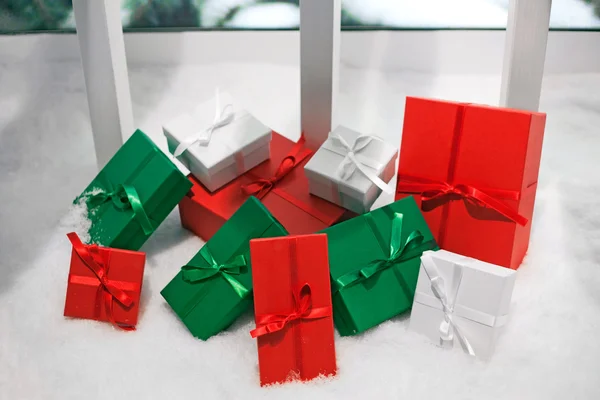 Coloured gift boxes on snowy background — Stock Photo, Image