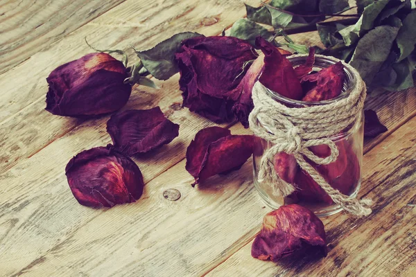 Getrocknete lila Rosen und Glas — Stockfoto