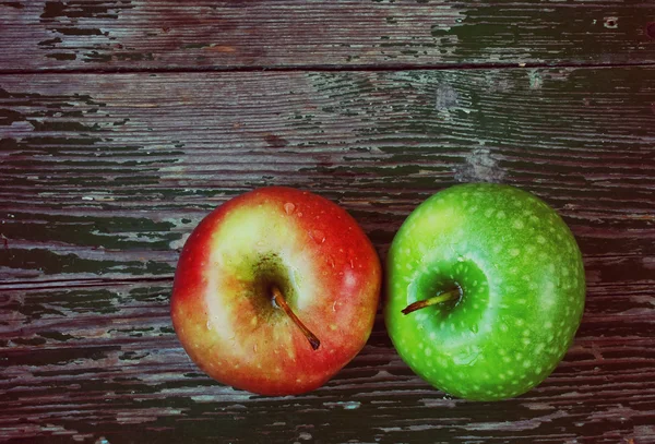 Two apples on wooden table