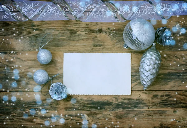 Рождественский фон с серебряными шариками, конусом, лентой — стоковое фото
