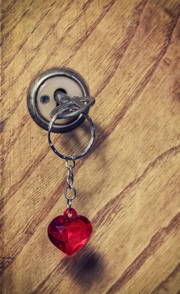 Old key with a keychain heart — Stock Photo, Image