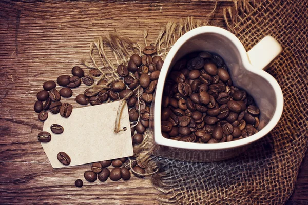 white cup with coffee beans