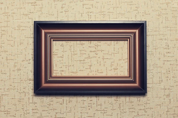 Wooden frame on beige paper background — Stock Photo, Image