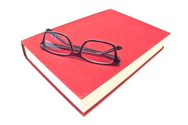 Gafas graduadas y libro aislado en blanco — Foto de Stock