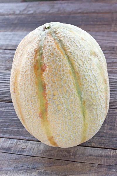 Cantaloupe melon on wooden background — Stock Photo, Image