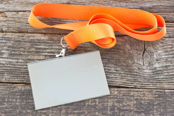 Blank  ID card tag with ribbon on wooden background — Stock Photo, Image