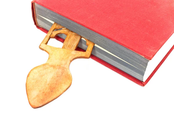 Wooden bookmark in a book on white — Stock Photo, Image