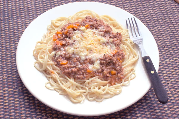 Spaghetti bolognese on plate with fork — Stock Photo, Image