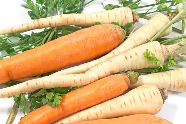 Frische Karotten und Petersilie mit Wurzel auf weiß — Stockfoto